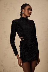A black velvet mini dress with cut out details and stud embellishments made by Yvette