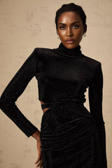 A black velvet mini dress with cut out details and stud embellishments