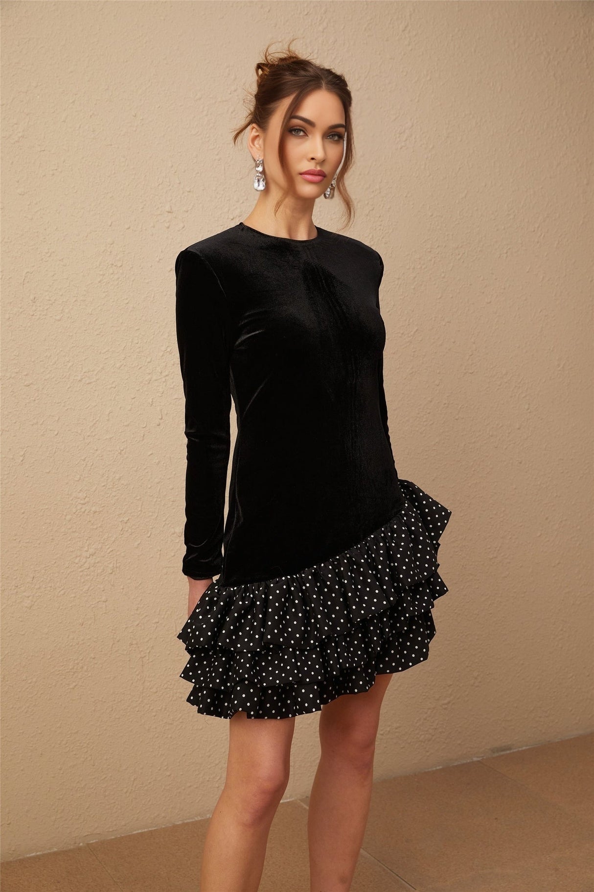 A black velvet mini dress with polka dot print featuring panelled design and ruffled details named Lucrezia