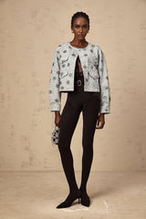 A blue denim jacket with sun motif studs decorating the fabric Katell brand visible on the garment