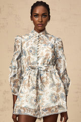 A blue floral print jumpsuit with ruffles and lace trim details named Eugenie