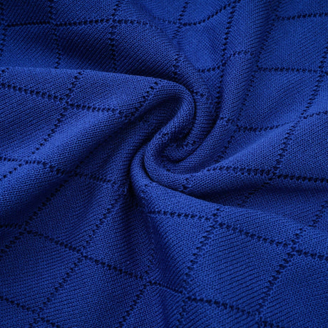 A blue knitted matching set featuring a top and skirt with button details The top has a fitted silhouette while the skirt is slightly flared Both pieces have a ribbed texture and coordinating button accents