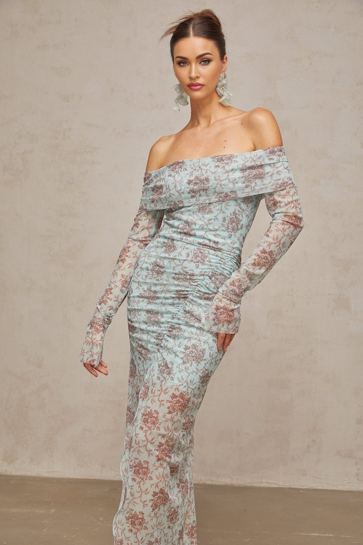 A blue maxi dress with a floral print pattern and ruched detailing by Honorine