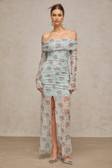 A blue maxi dress with floral print pattern and ruched detailing by Honorine