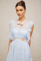 A blue maxi dress with layered lace detailing and a capucine style neckline on a plain background