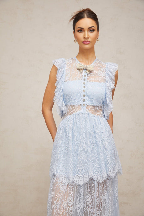 A blue maxi dress with layered lace details and a capucine style featuring a long flowing skirt and delicate lace overlay