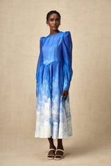 A blue midi dress with a gradient color effect and pleated design named Adonia