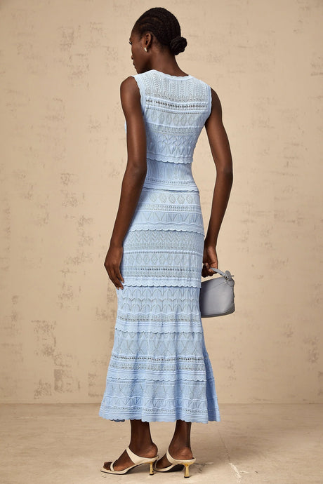 A blue midi dress with ruffled trim and crochet knit pattern featuring a feminine silhouette