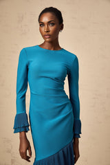 A blue midi dress with ruffled trim and panelled design featuring a flowing silhouette and feminine details