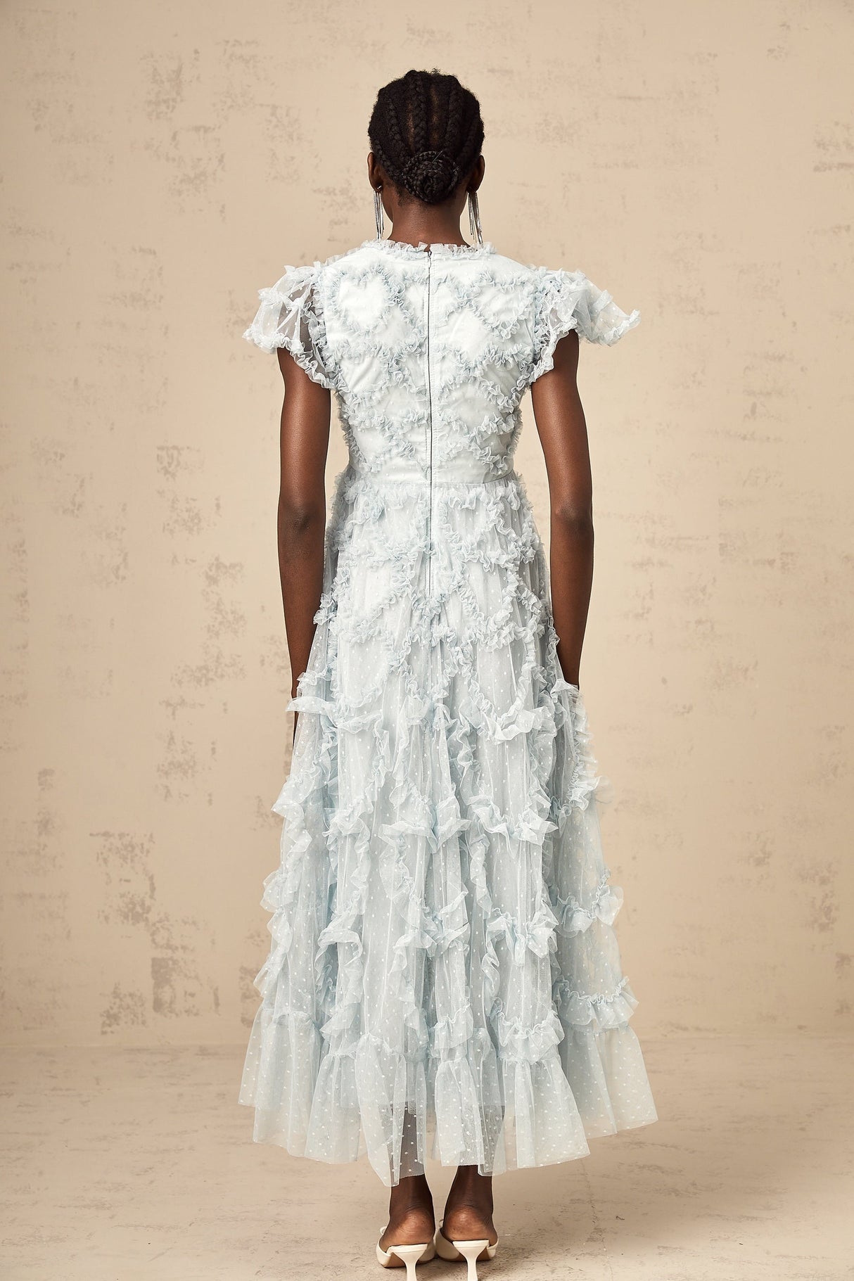 A blue midi dress with ruffles and small dot details named Corinna