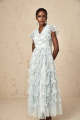 A blue midi dress with ruffles and small dot details named Corinna