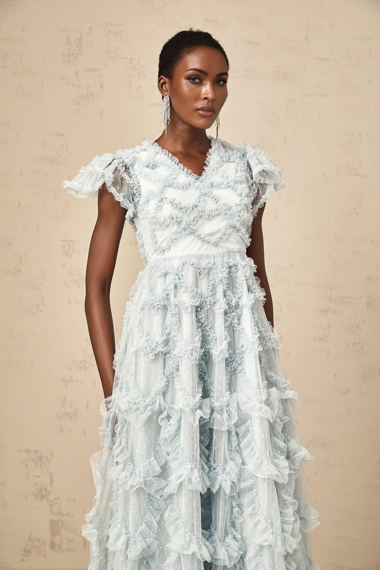 A blue midi dress with ruffles and small dot details named Corinna