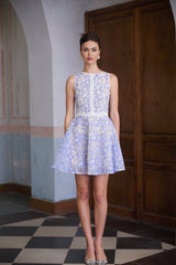 A blue mini dress with crochet lace detailing and puff sleeves named Brigitte