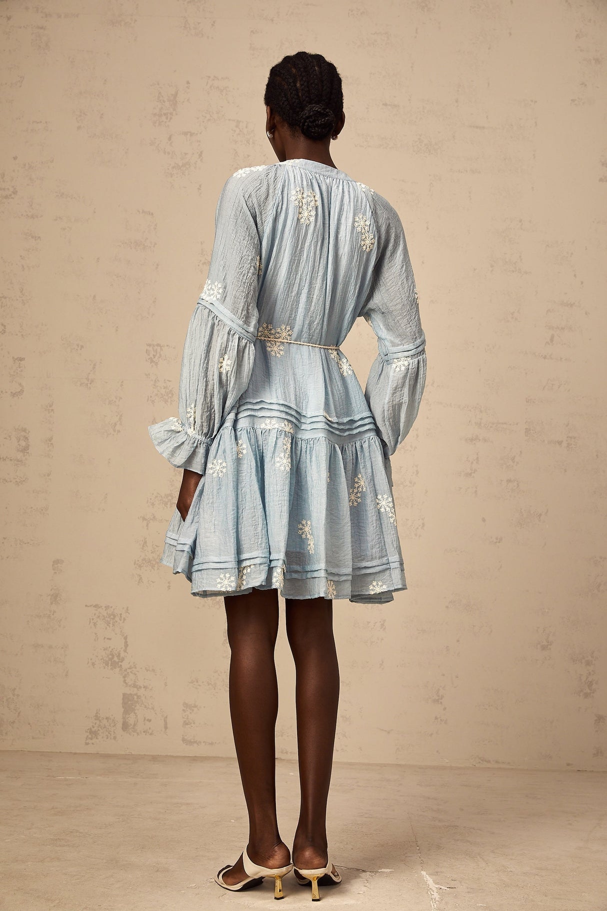 A blue mini dress with delicate floral embroidery details featuring a feminine and elegant design