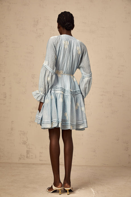 A blue mini dress with delicate floral embroidery details featuring a feminine and elegant design