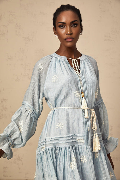 A blue mini dress with delicate flower embroidery details featuring a feminine and elegant design