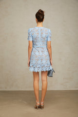 A blue mini dress with floral applique and ruffled lace details featuring a feminine design with a short hemline