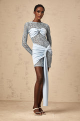 A blue mini dress with floral lace panels and a fitted silhouette