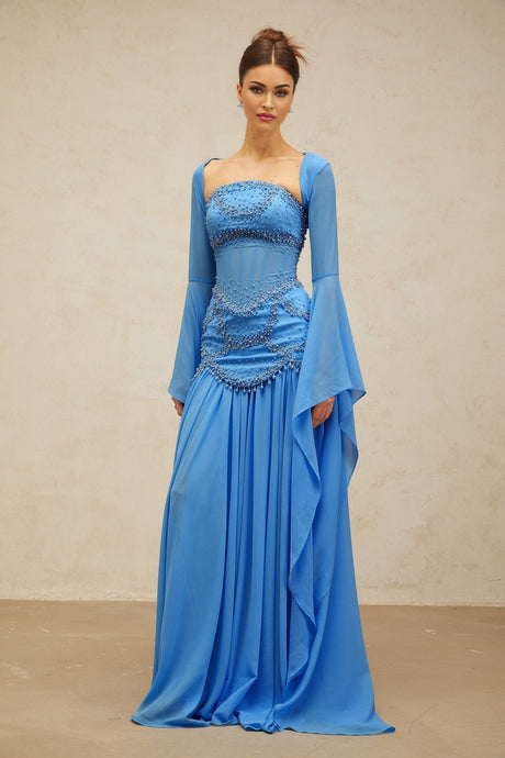 A blue pleated maxi dress with faux pearl embellishments by Gaelle