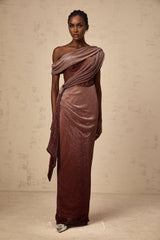 A brown maxi dress with a corsetstyle bodice featuring ribbon detailing and a long flowing skirt