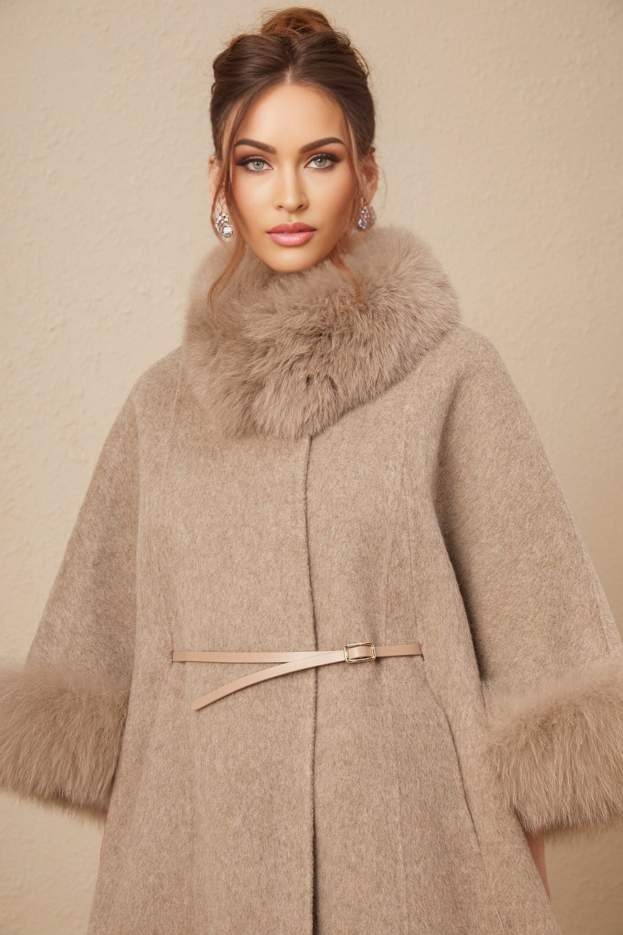 A brown wool cape coat with fur trim and a belt cinching the waist