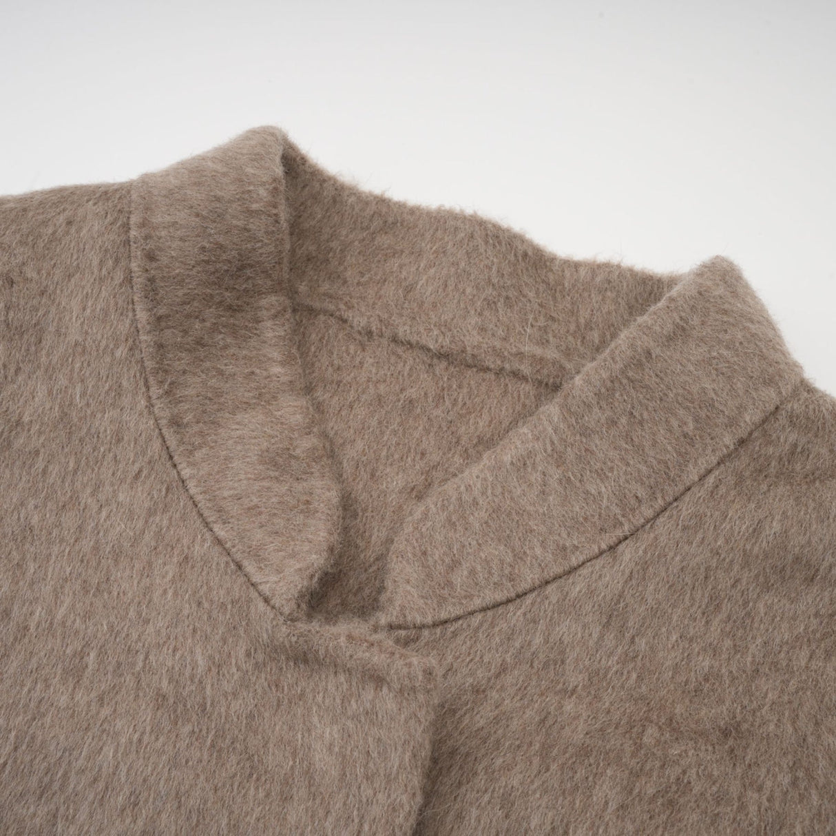 A brown wool cape coat with fur trim and belt cinched at the waist