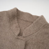 A brown wool cape coat with fur trim and belt cinched at the waist