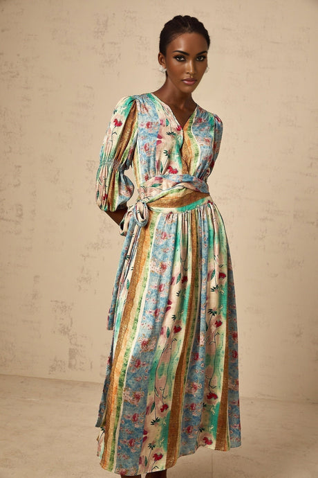 A cerise colored midi dress with a floral print pattern and a wrap style design