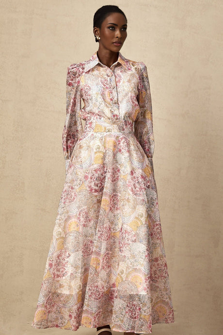 A child wearing a cherry pink shirt and skirt set with a pattern print design The top and bottom match creating a coordinated outfit