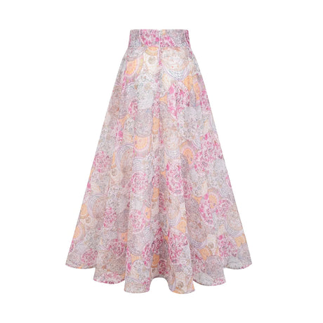 A child wearing a matching set consisting of a cherry pink shirt and skirt both featuring a pattern print design