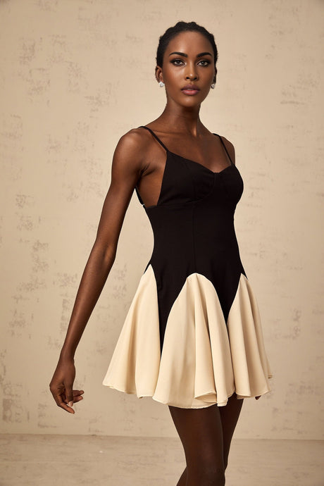 A colorblocked mini dress with godet pleated skirt featuring contrasting panels and a short hemline