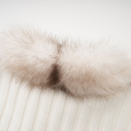 A cozy faux fur jacket with ribbed knit texture in a neutral color worn by a model against a plain background