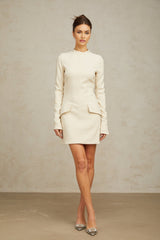 A creamwhite fitted mini dress by Chloé on a plain background showcasing its sleek design and elegant silhouette