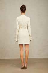 A creamwhite fitted mini dress by Chloé on a plain background showcasing its sleek silhouette and elegant design