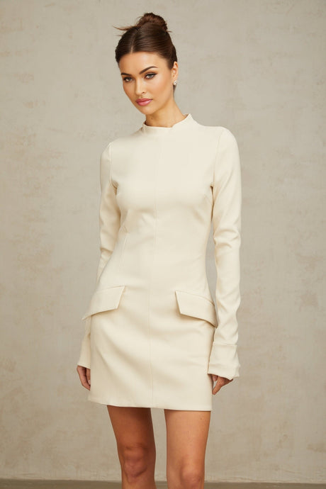 A creamwhite fitted mini dress by Chloé on a plain background showcasing its sleek silhouette and elegant design