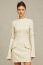 A creamwhite fitted mini dress by Chloé on a plain background