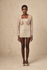 A cropped jacket with a dark background featuring studded embellishments and a boxy silhouette named Ubalda