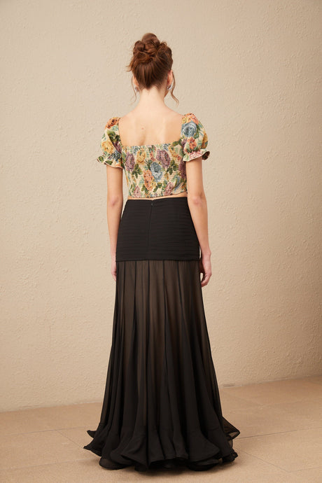 A cropped top with a floral print pattern in jacquard fabric named Constance featuring a colorful design on a textured background