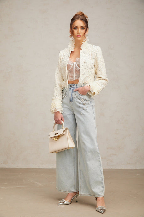 A cropped white jacket with beaded embellishments and ruffled details named Blanche