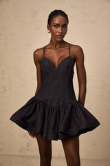 A dark blue denim mini dress with flounce detailing called Genevieve