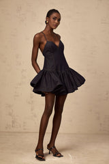 A dark blue denim mini dress with flounce details named Genevieve