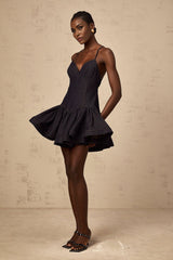 A dark blue denim mini dress with flounce details named Geneviève
