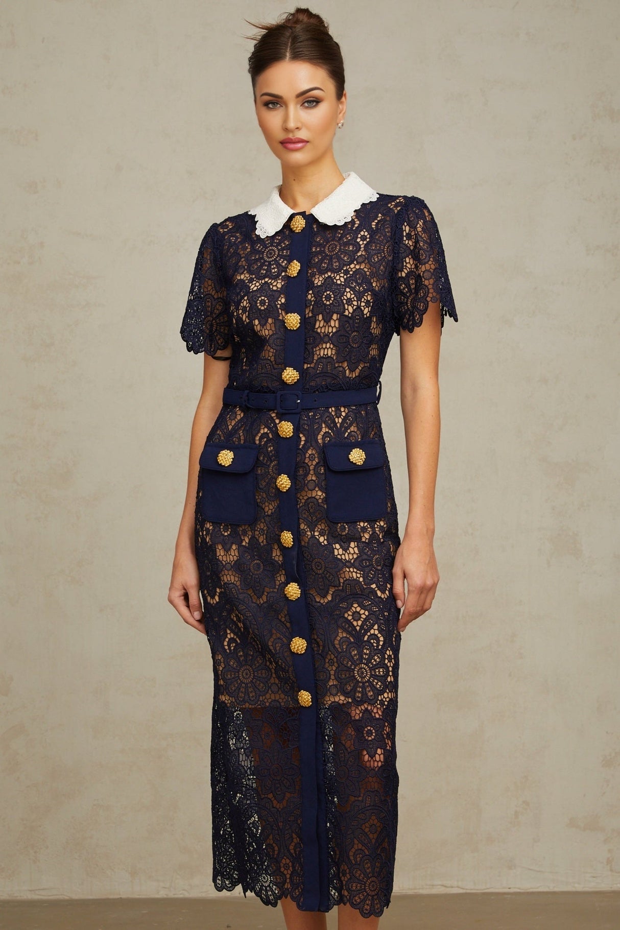A dark blue midi dress with a floral crochet lace pattern covering the entire garment