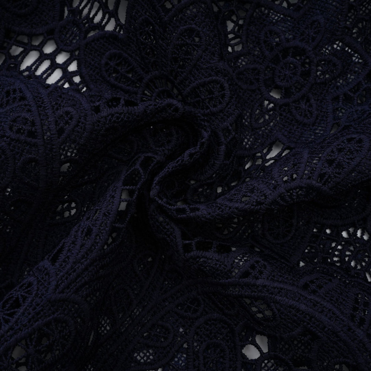 A dark blue midi dress with floral crochet lace pattern and a fitted silhouette