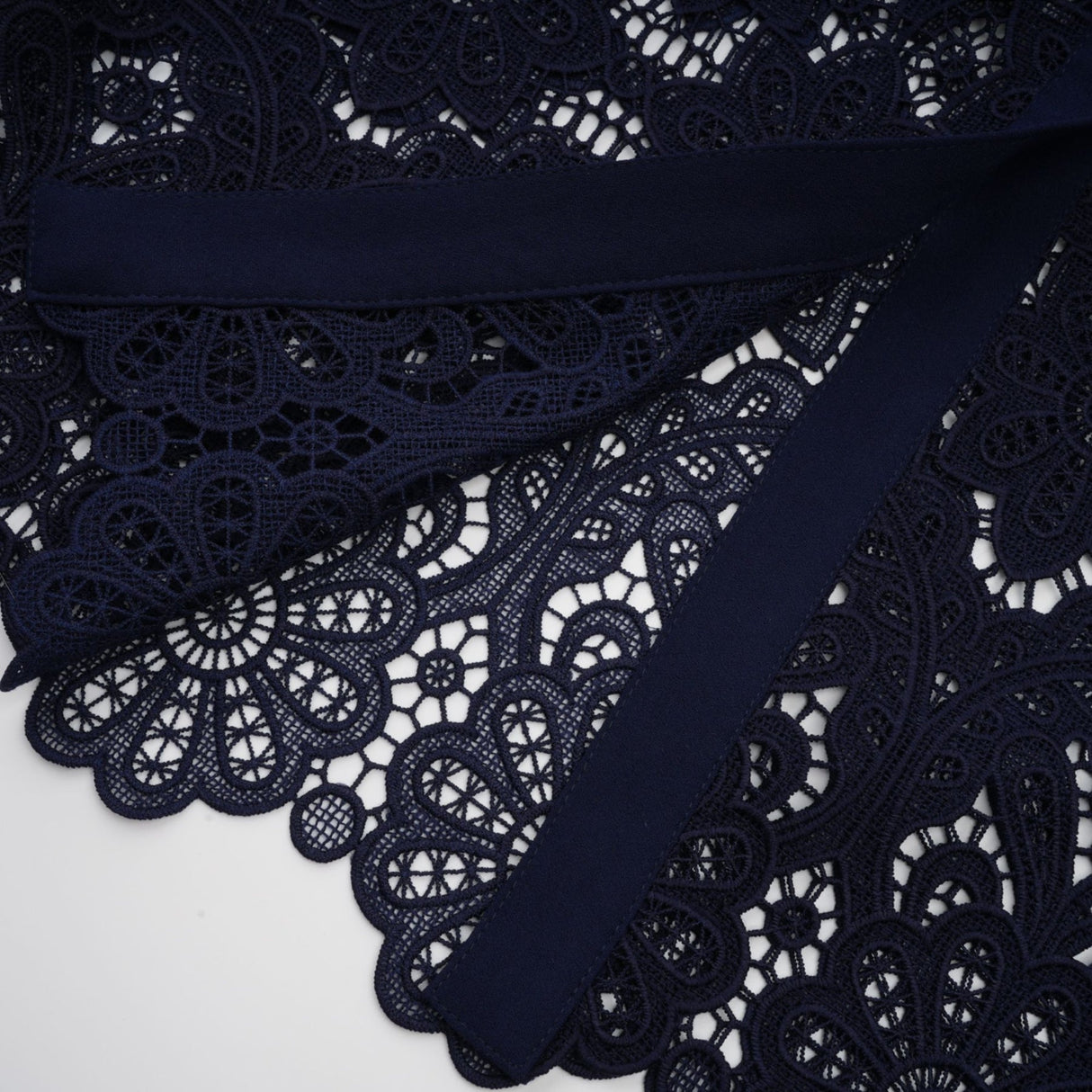 A dark blue midi dress with floral crochet lace pattern and delicate detailing