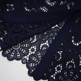 A dark blue midi dress with floral crochet lace pattern and delicate detailing