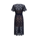 A dark blue midi dress with floral crochet lace pattern covering the bodice and skirt