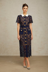 A dark blue midi dress with floral crochet lace pattern featuring an intricate design throughout the garment
