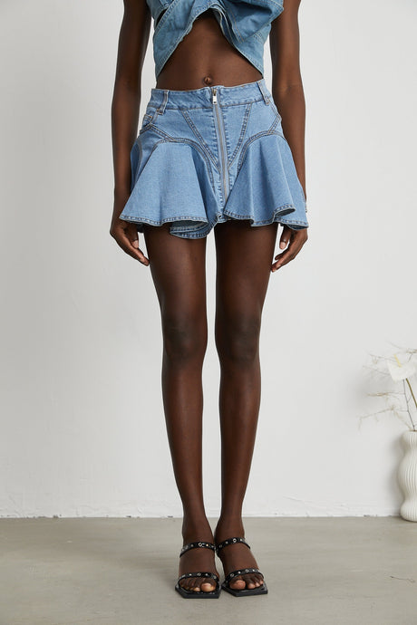A denim skirt with a ruffled hem named Capucine Denimrock featuring a volant bottom edge