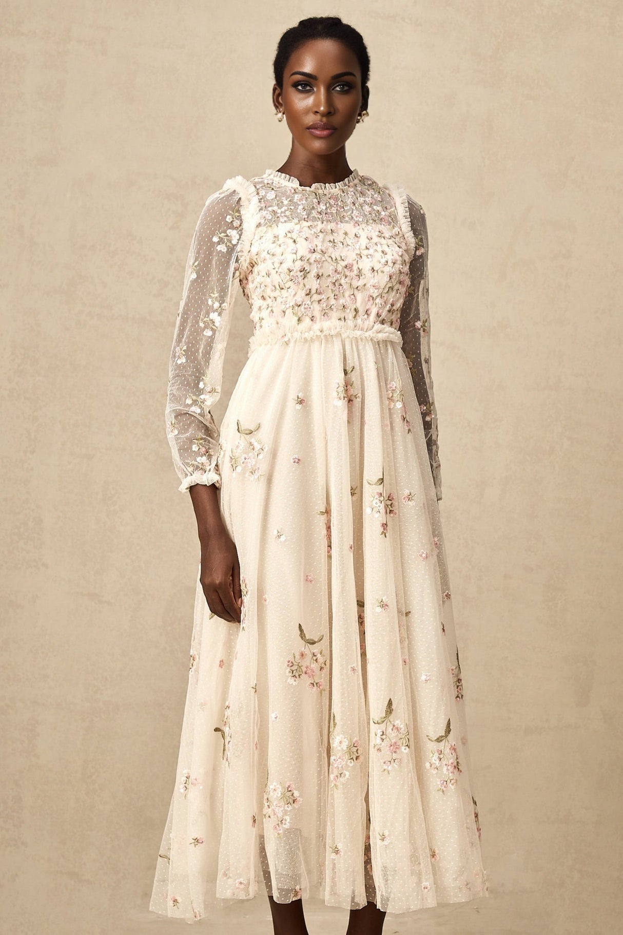 A elegant midi dress with floral embroidery on tulle fabric designed by Celine featuring delicate floral patterns on a sheer overlay